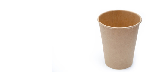 Brown paper cup for coffee, tea, a drink from environmental materials on a white background. A small cup in macro is on the right. Front view and top view, bottom visible. Place for text on the left