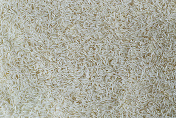 Texture of raw basmati rice. Scattered grains. Background.