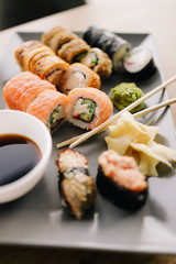 Freshly cooked sushi chef, delicious big rolls with avocado, cheese, salmon, sesame seeds