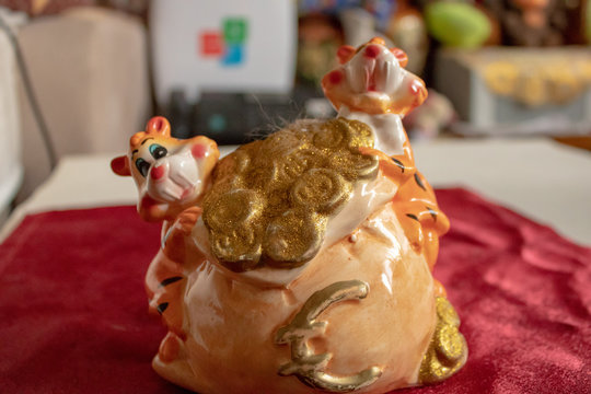 Decorative toy tiger cubs with gold coins.