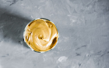 Dalgona coffee top view with copy space on gray background.