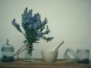 Veronica blue flowers in a glass bottle and seeds in a glass bottle.