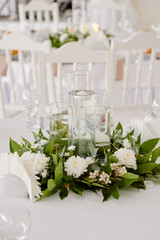 Lush floral arrangement of white chrysanthemum flowers and candles on table, copy space. Luxury wedding decorations
