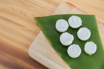 Thai dessert coconut milk custard on banana leaf serve on wooden background