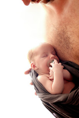 Happy father's day! A newborn baby in dad’s arms is sleeping, a pacifier for babies. Happy fatherhood concept. Copy space
