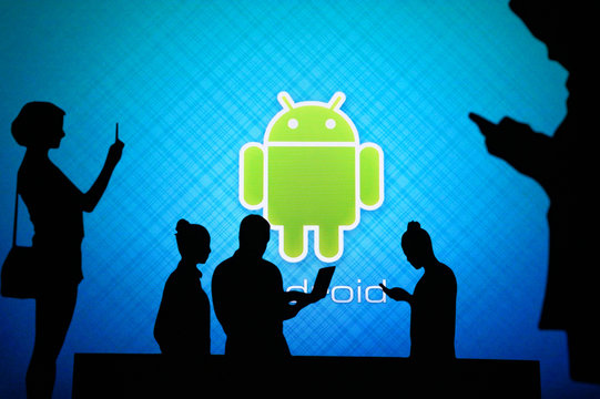 NEW YORK, USA, 25. MAY 2020: Android Mobile Operating System Group Of Business People Chat On Mobile Phone And Laptop. Company Logo On Screen In Background