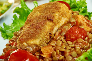 Harissa crumbed fish with lentils