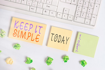 Conceptual hand writing showing Keep It Simple. Concept meaning to make something easy to understand and not in fancy way Flat lay above blank copy space sticky notes with business concept