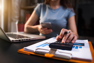 Fototapeta premium Hand man doing finances and on desk about cost at office. 