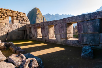 Ancient windows of the Inca ruins of Machupicchu creating shadow