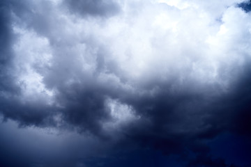 white dramatic clouds floating in the blue sky