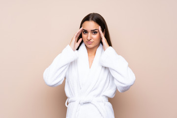 Young girl in a bathrobe over isolated background unhappy and frustrated with something. Negative...