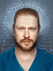Man With QR Code On Forehead On Background Of Fluorescent Chip, front view portrait.