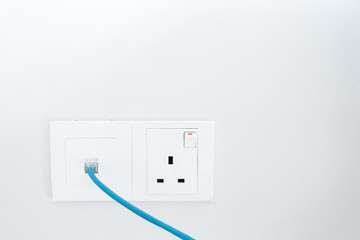 Power socket and Internet socket. Socket Malaysian type. Socket with switch on a white wall.