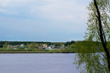 Stormy sky reflected in the river and forest in the background. Before the rain