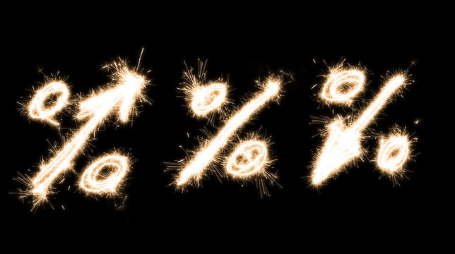 Symbolic image of a percentage sign of burning sparklers isolated.