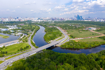 panoramic views of the river with a forest and reflection of clouds in the river taken from a drone
