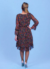 portrait Attractive young blonde model posing in trendy dress isolated at blue studio background. Beautiful girl standing in trendy clothing looking at camera