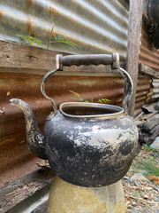 old vintage teapot on denim background.