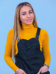 portrait Attractive young blonde pretty young model girl in sportswear posing in blue backround