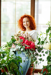 Lovely red-haired girl holding a bouquet of fresh flowers