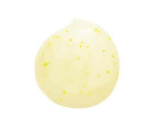 Scrub cleanser gel drop swatch isolated on white background. Yellow color skincare cleansing product with exfoliating particles blob closeup