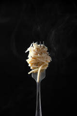 Spaghetti on Fork with Steam on Dark Background. Cacio e Pepe - Italian Pasta with Cheese and Pepper