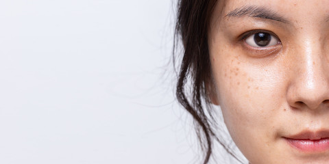 Close up half fresh face of Asian women is looking at camera on white banner background with copy...