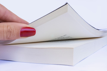 Curious woman with red manicure opening book, on white background. Studying concept, education, literature for women, daily planner, leisure and hobbies.