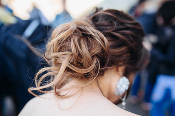 Fototapeta premium The beauty of a wedding hairstyle. Bride. A brunette brown-haired with curly hair.Hair decoration