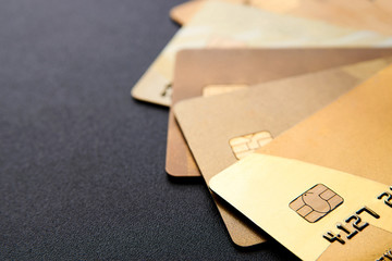 Gold credit cards on black background with copy space
