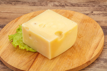 Emmental cheese over wooden board