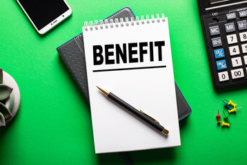 Benefit planning on a sheet of paper on a green background