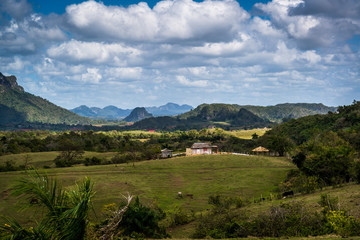 Fototapeta premium Farm houses and agricultural land in the Vinales Valley, know for its unique mountain karst formations called magote, Cuba