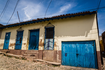 Typical cobblestoned street with colourful houses in the old colonial centre of the town, Trinidad,...