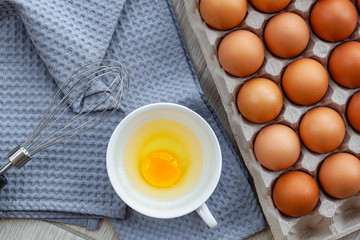 Whisk egg near the brown eggs