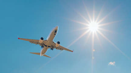 Fototapeta na wymiar Airplane in the sky with sun rays