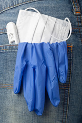 Facial mask, thermometer and latex glove in back pocket