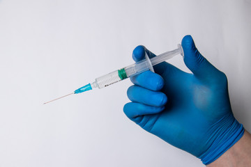 Syringe, medical injection in the hands, palms or fingers. Medicine plastic vaccination equipment with a needle. Nurse or doctor. Liquid drug or drug. Medical care in the hospital.