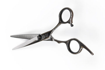 Professional hairdresser scissors, on a white background, top view