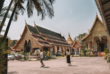 Couple at a buddhist temple in the city of Chiang Mai, Thailand