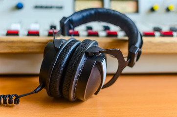 Obraz na płótnie Canvas sound mixer and headphones in radio station studio