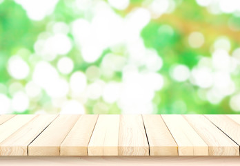 blurred background of green park in summer, Wood table top on shiny bokeh green background. For product display