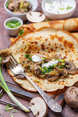 Homemade crepes with mushroom and cabbage filling for breakfast.