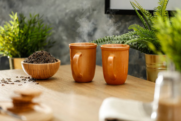 Hot tea on the table while relaxing with free space for an advertising product