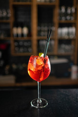 Campari tonic in glasses on a black bar counter