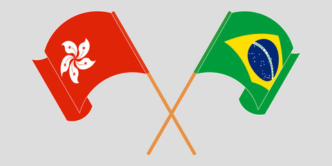 Crossed and waving flags of Hong Kong and Brazil
