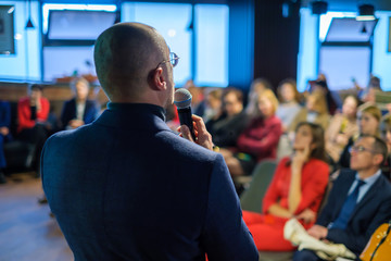 Male presenter speaks to audiences