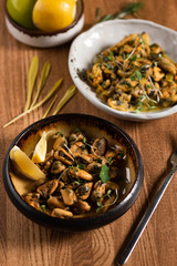 fried mussels with lemon and microgreens. close-up