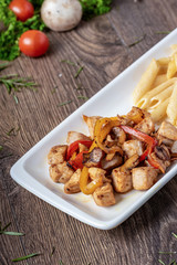 grilled cubed chicken with pasta and salad